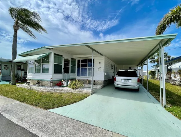 a view of a house with swimming pool and porch