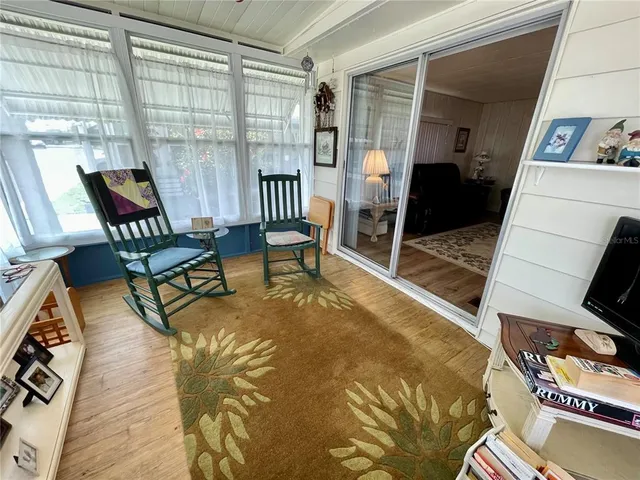 a view of a livingroom with furniture and a window