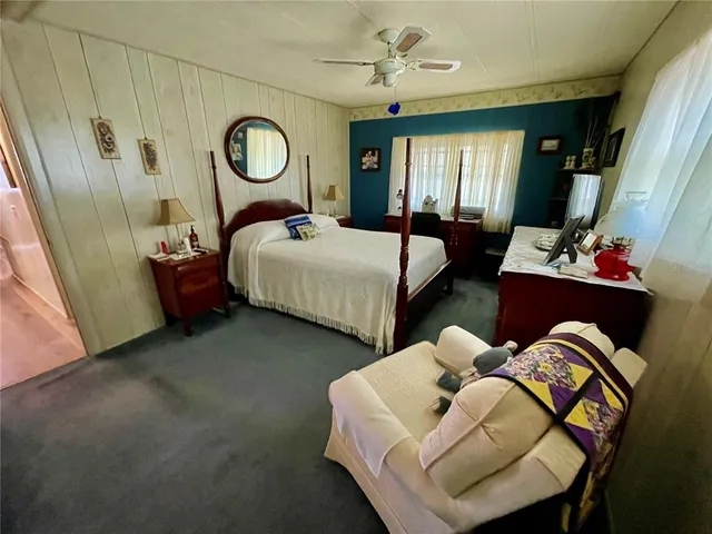 a bed room with bed and a chair