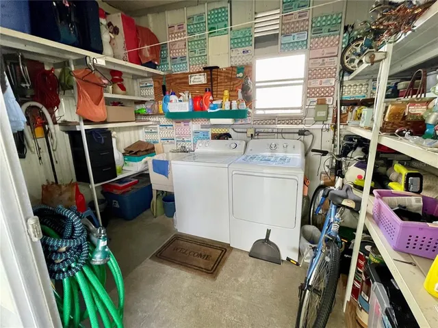 a utility room with dryer washer and other items
