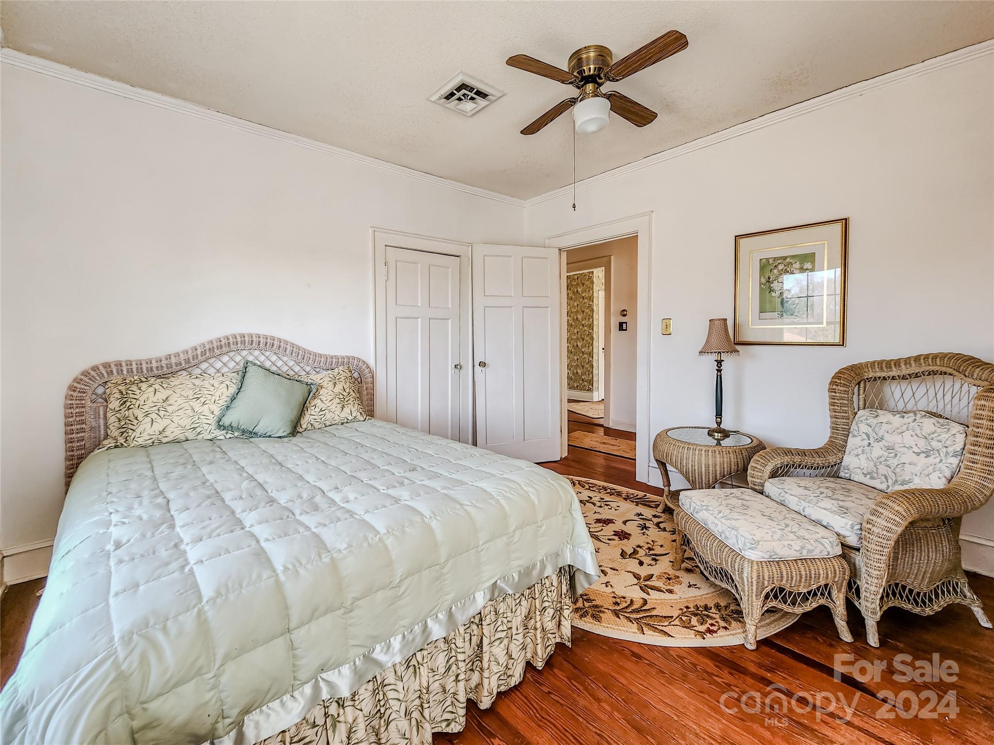 535 North Washington Street Rutherfordton, NC 28139 - Photo 24 of 48 a spacious bedroom with a bed and a chandelier