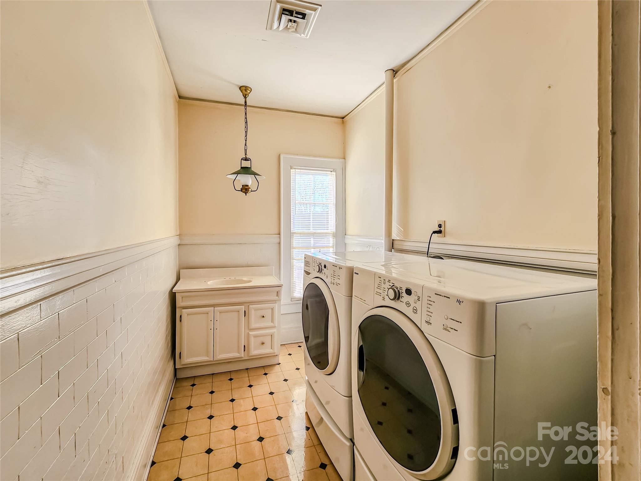 535 North Washington Street Rutherfordton, NC 28139 - Photo 26 of 48 a bathroom with a sink a washer and dryer