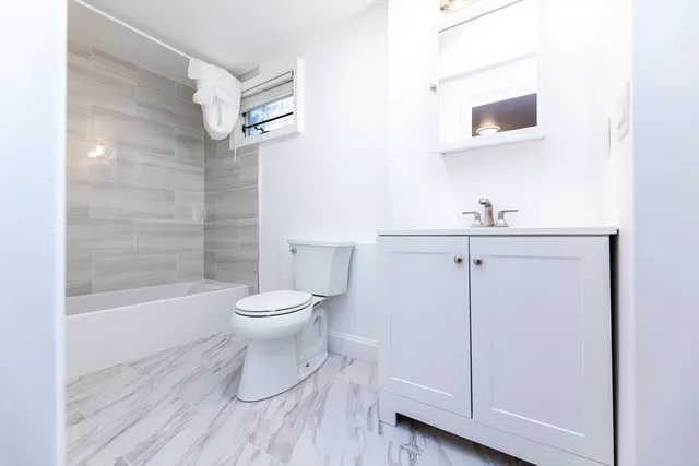a bathroom with a toilet a sink and bathtub