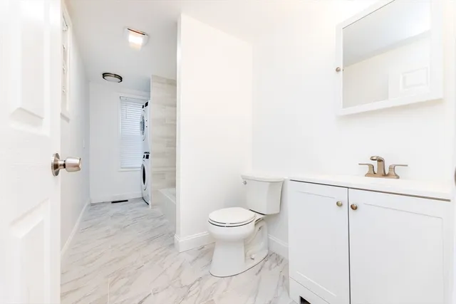 a bathroom with a toilet sink and a shower