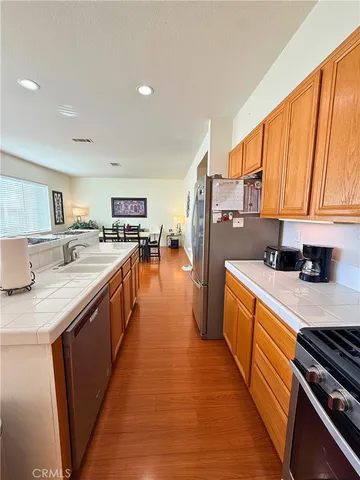 a kitchen with stainless steel appliances a sink stove and cabinets