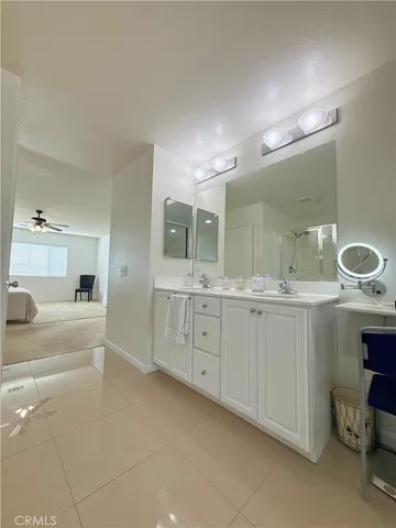 a spacious bathroom with a granite countertop sink mirror and bathtub