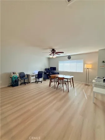 a dining room with furniture and a floor to ceiling window