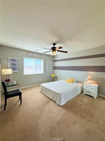 a bedroom with furniture and a window