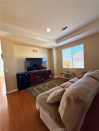 a bedroom with two beds and a television