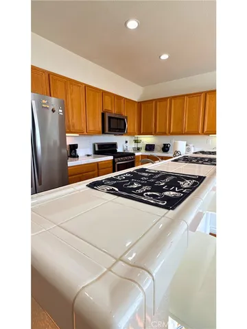 a kitchen with a refrigerator a stove a sink and a microwave