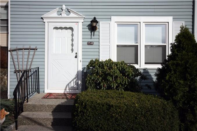 55 Mill Plain Road, Unit 134 Danbury, CT 06811 - Photo 1 of 1 a front view of a house with a yard