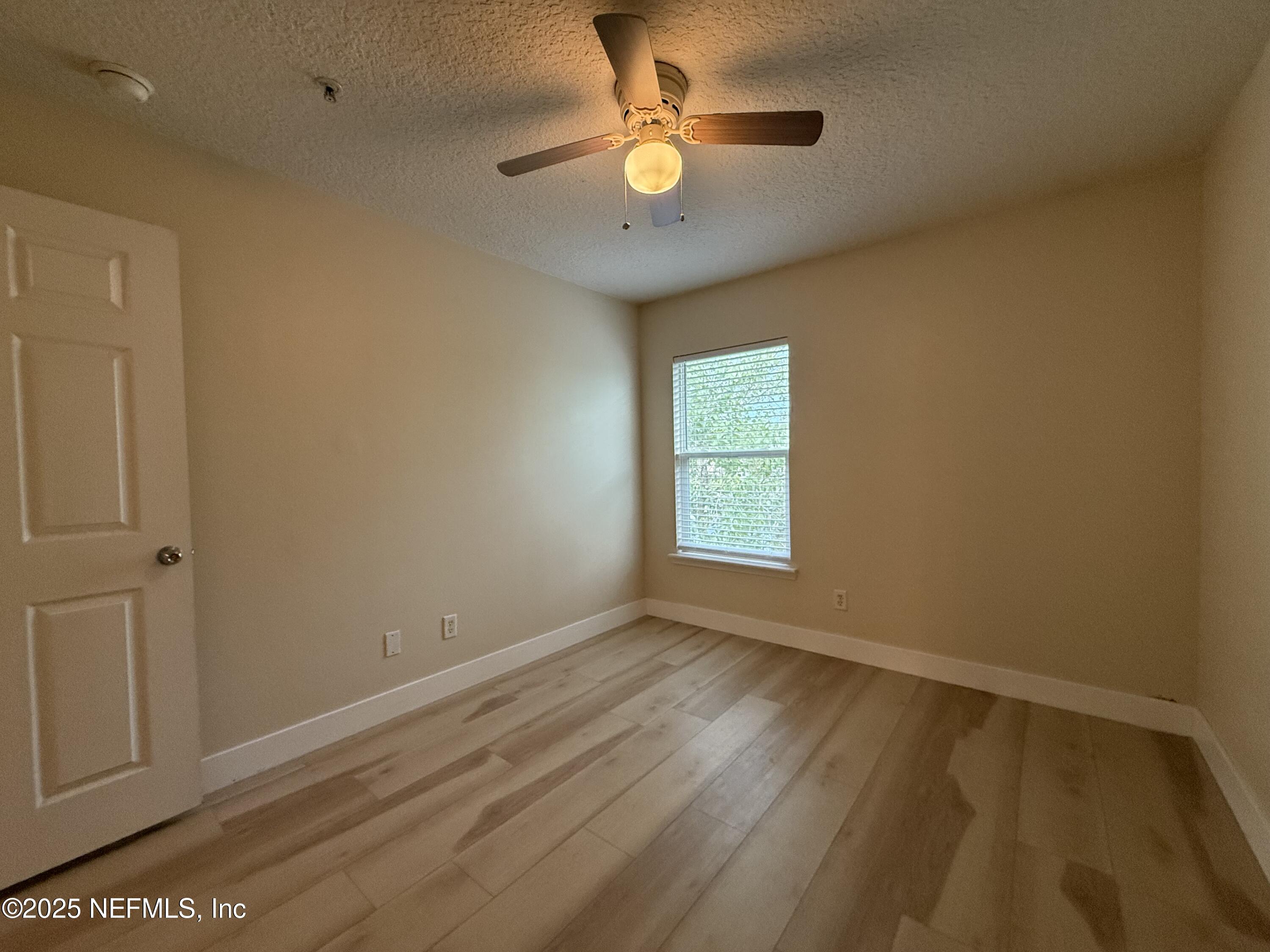 2564 Golden Lake Loop St. Augustine, FL 32084 - Photo 11 of 24 wooden floor in an empty room with a window