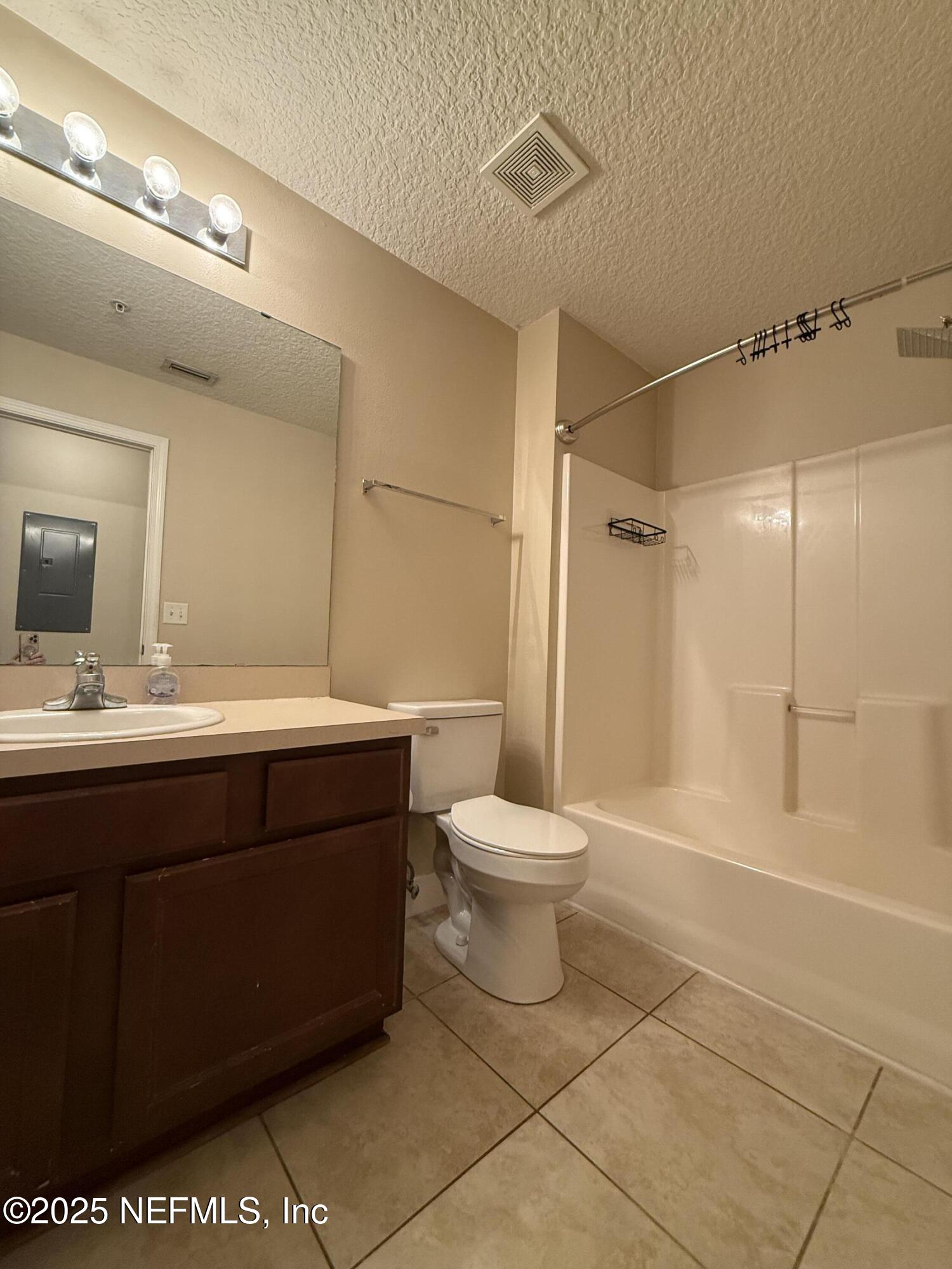 2564 Golden Lake Loop St. Augustine, FL 32084 - Photo 12 of 24 a bathroom with a sink a toilet and a mirror