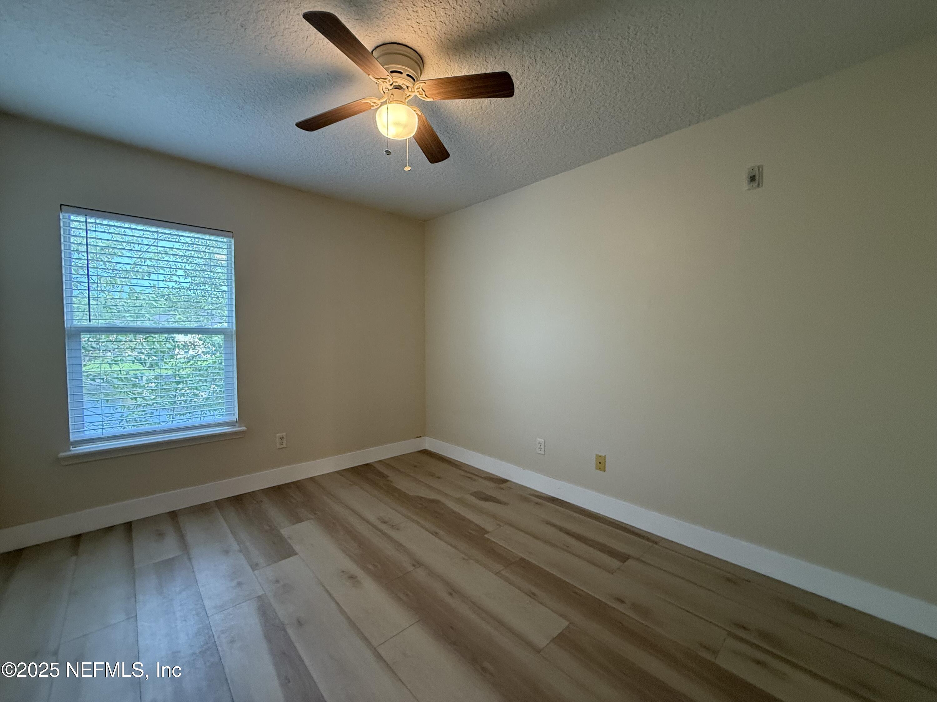 2564 Golden Lake Loop St. Augustine, FL 32084 - Photo 13 of 24 an empty room with a window and ceiling fan