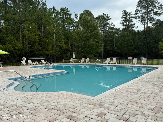 a view of a swimming pool with a patio