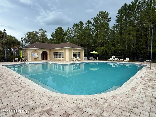 a view of a house with a backyard and a swimming pool