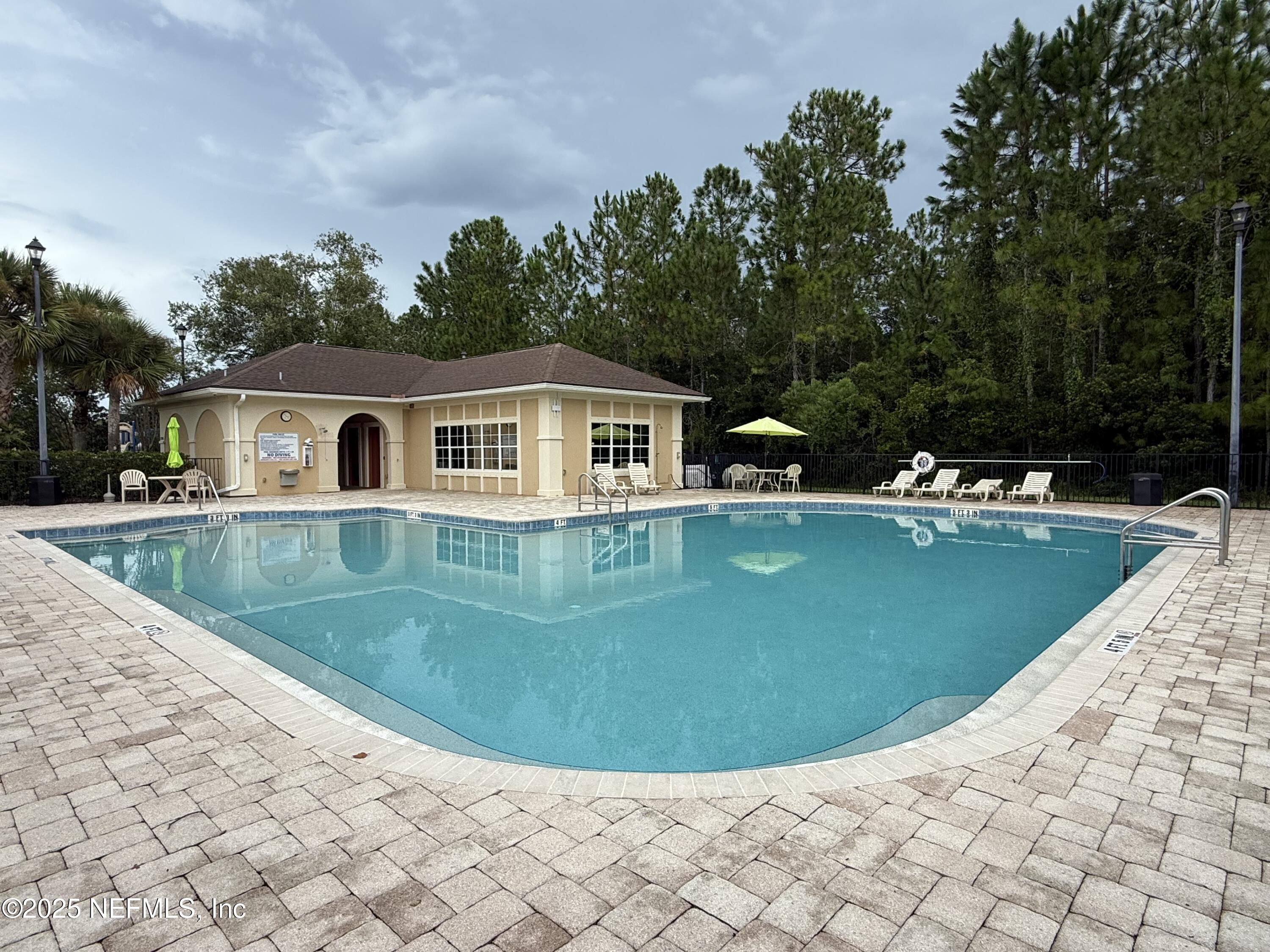 2564 Golden Lake Loop St. Augustine, FL 32084 - Photo 21 of 24 a view of a house with a backyard and a swimming pool