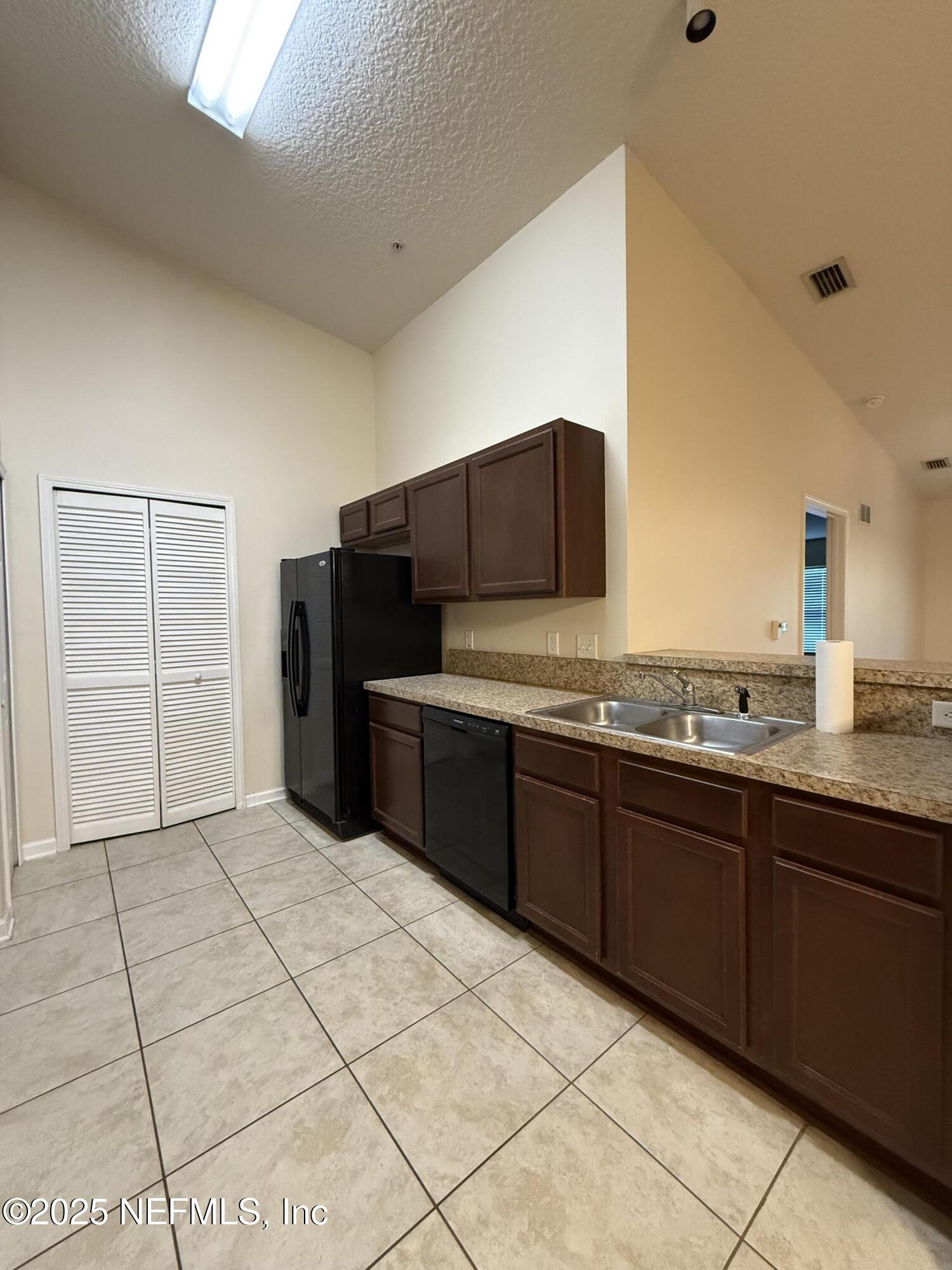 2564 Golden Lake Loop St. Augustine, FL 32084 - Photo 3 of 24 a kitchen with stainless steel appliances a sink and cabinets