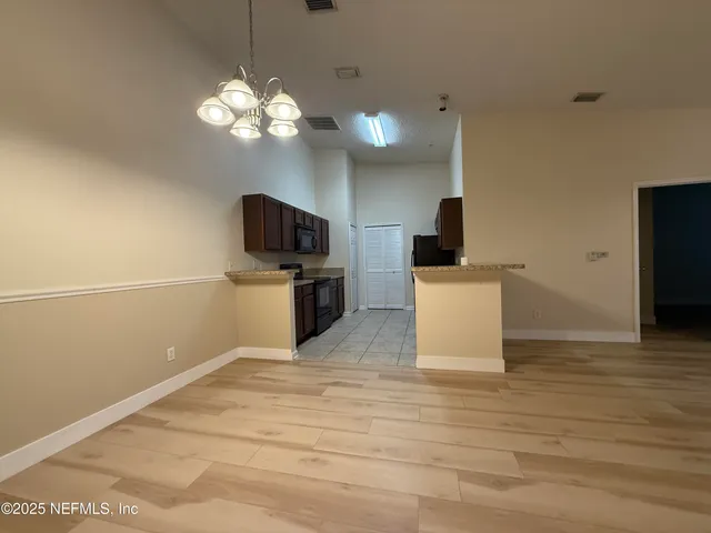 a kitchen with stainless steel appliances a stove top oven a sink and a refrigerator