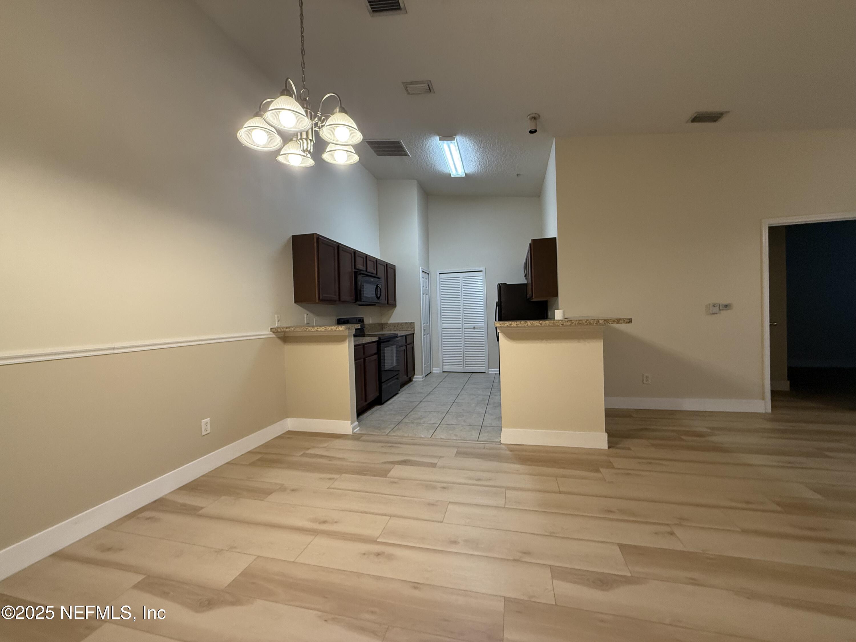 2564 Golden Lake Loop St. Augustine, FL 32084 - Photo 4 of 24 a kitchen with stainless steel appliances a stove top oven a sink and a refrigerator