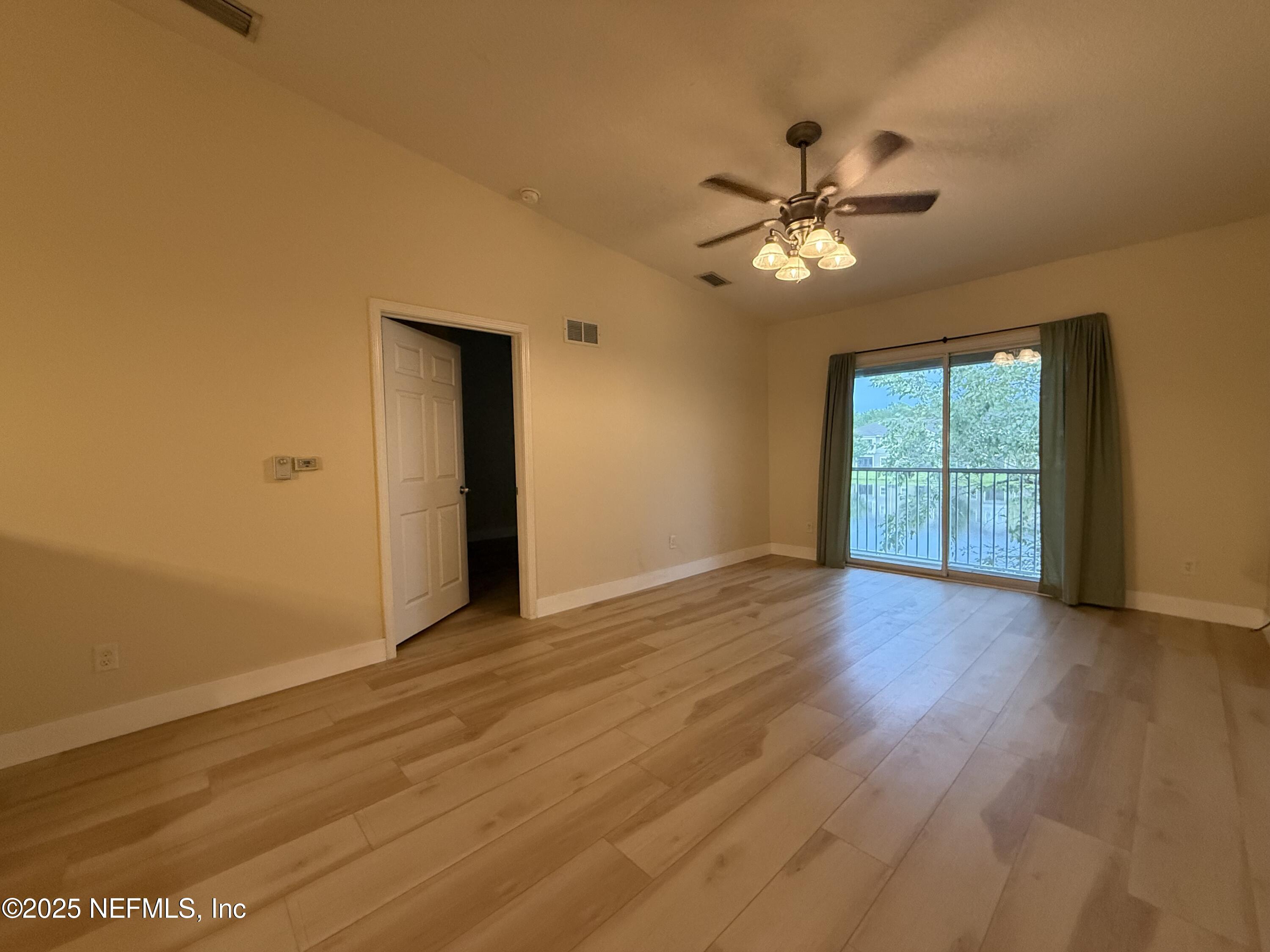 2564 Golden Lake Loop St. Augustine, FL 32084 - Photo 5 of 24 a view of empty room with wooden floor and fan
