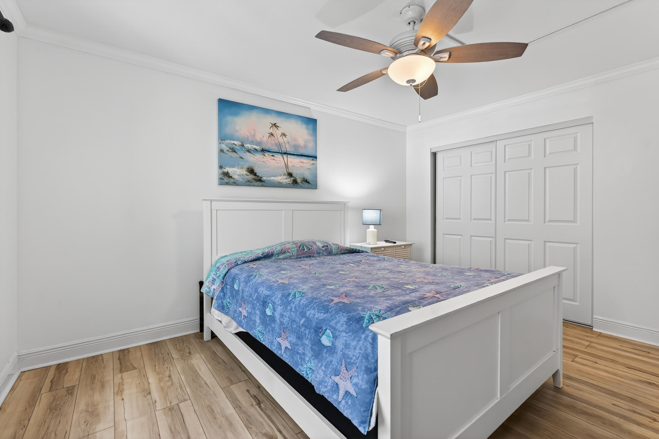 151 Calhoun Avenue, Unit 301 Destin, FL 32541 - Photo 19 of 43 a bedroom with a bed and a chandelier