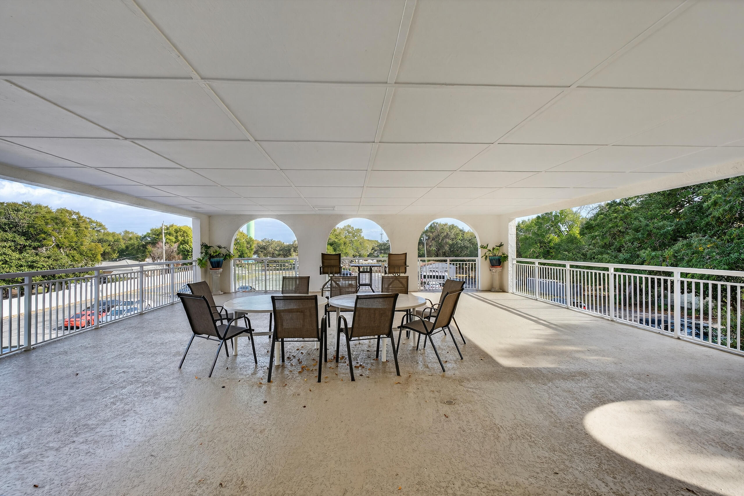 151 Calhoun Avenue, Unit 301 Destin, FL 32541 - Photo 30 of 43 a view of a patio with a table chairs and a backyard