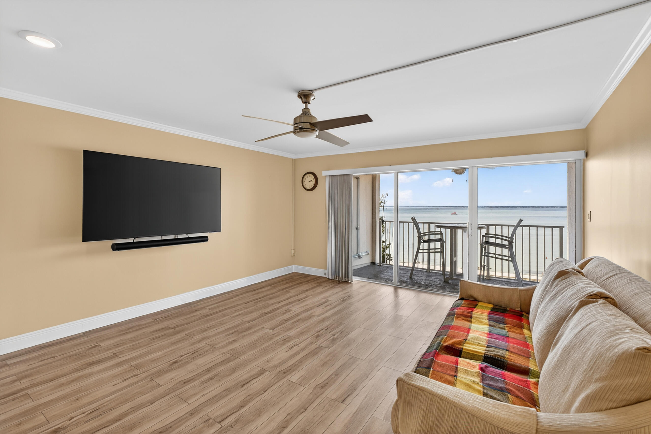 151 Calhoun Avenue, Unit 301 Destin, FL 32541 - Photo 6 of 43 a living room with furniture a flat screen tv and a floor to ceiling window