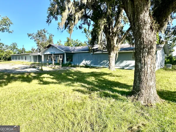 a view of a house with swimming pool and sitting area