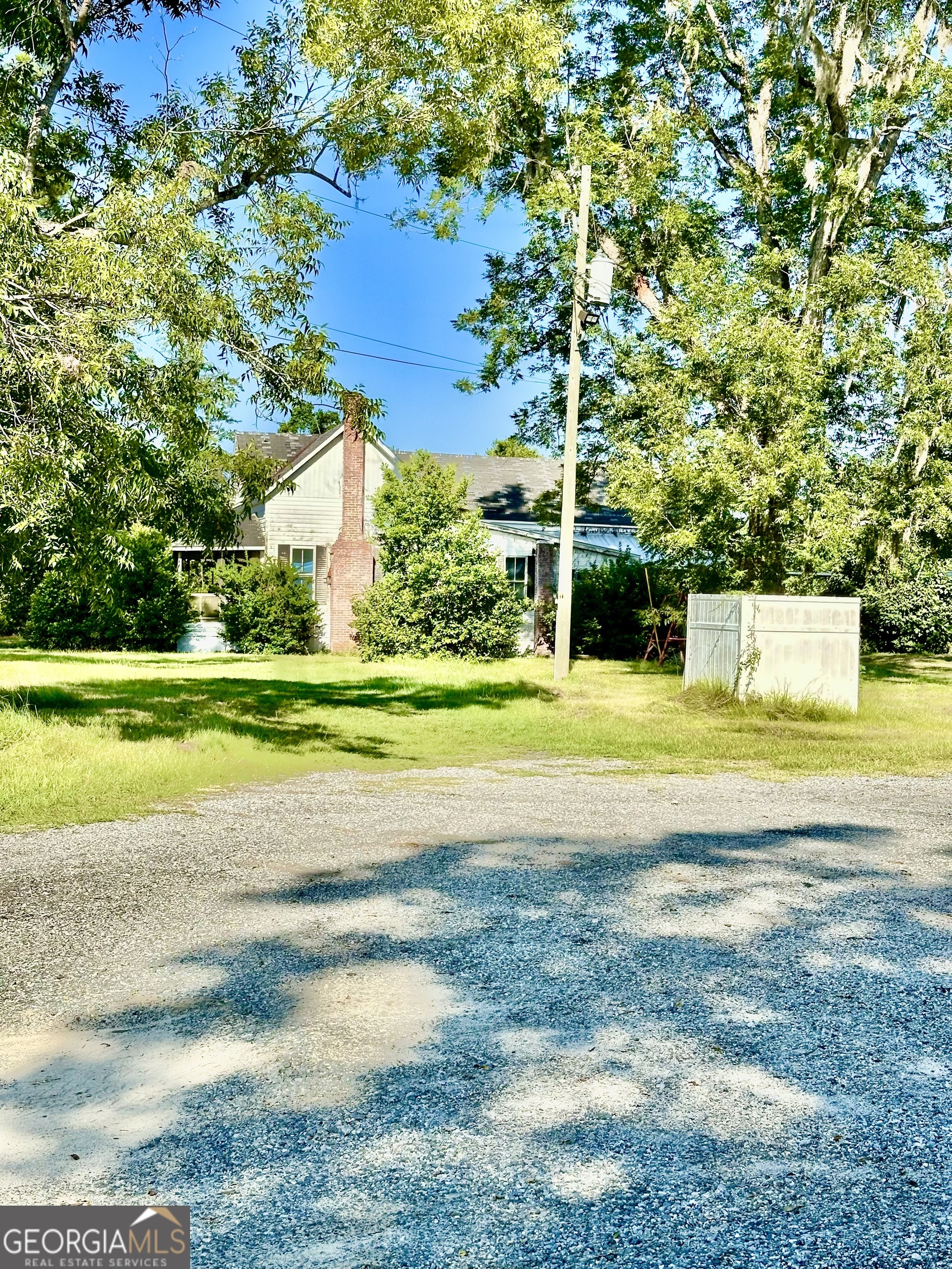3344 Strickland Avenue Blackshear, GA 31516 - Photo 17 of 17 a view of a house with a big yard and large trees