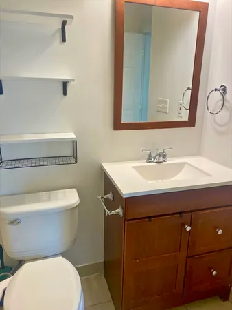 a bathroom with a sink toilet and mirror