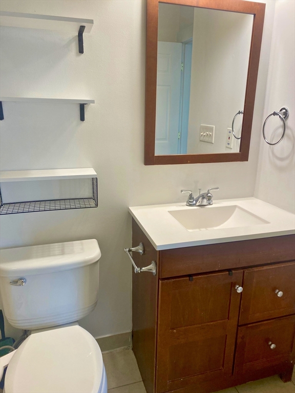 30 Maple Avenue, Unit 2 North Andover, MA 01845 - Photo 13 of 17 a bathroom with a sink toilet and mirror