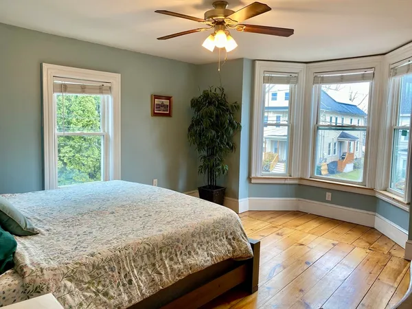 a spacious bedroom with a large bed and a window