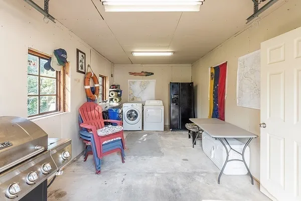 a living room with furniture a flat screen tv and a window