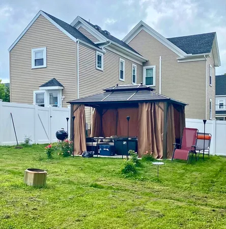 a front view of house with yard and outdoor seating