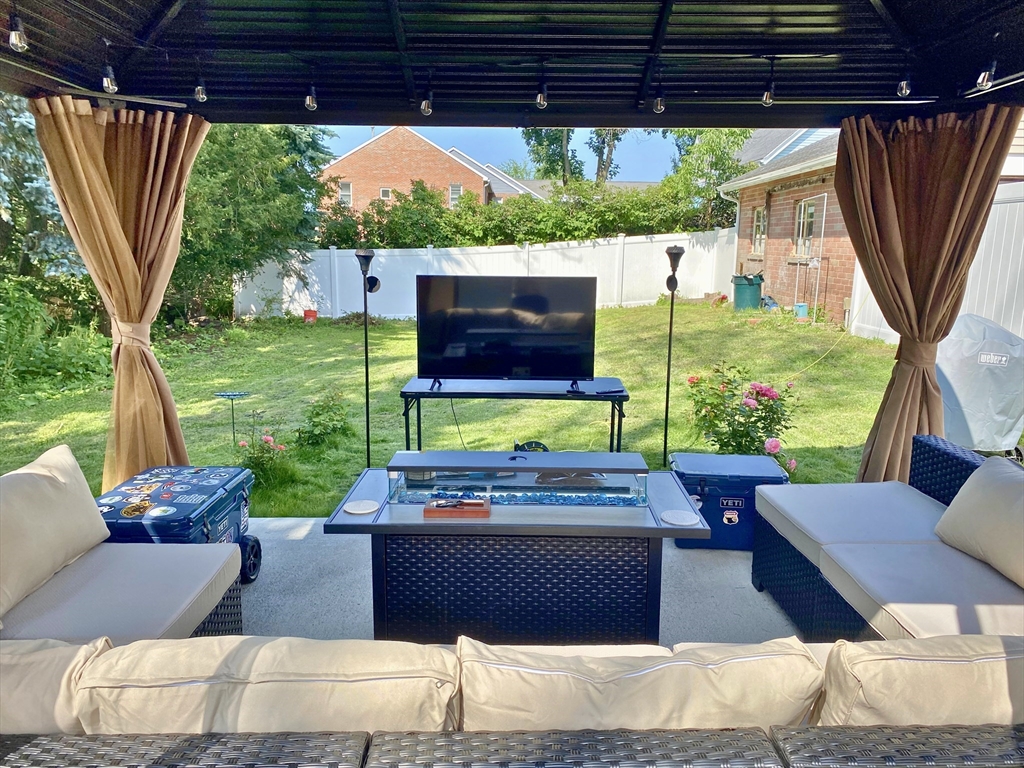 30 Maple Avenue, Unit 2 North Andover, MA 01845 - Photo 4 of 17 a view of a patio with table and chairs potted plants with wooden floor and a garden view