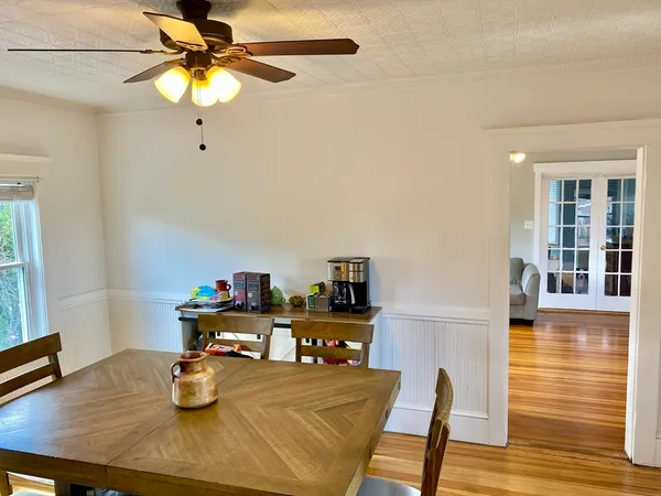 a view of a dining room with furniture and wooden floor
