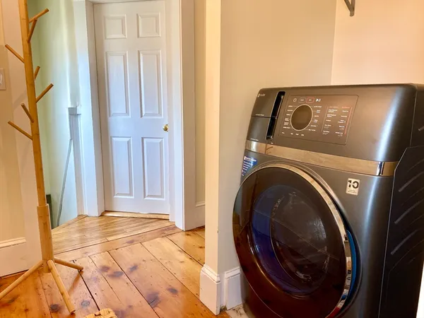 a view of a hallway with washer and dryer