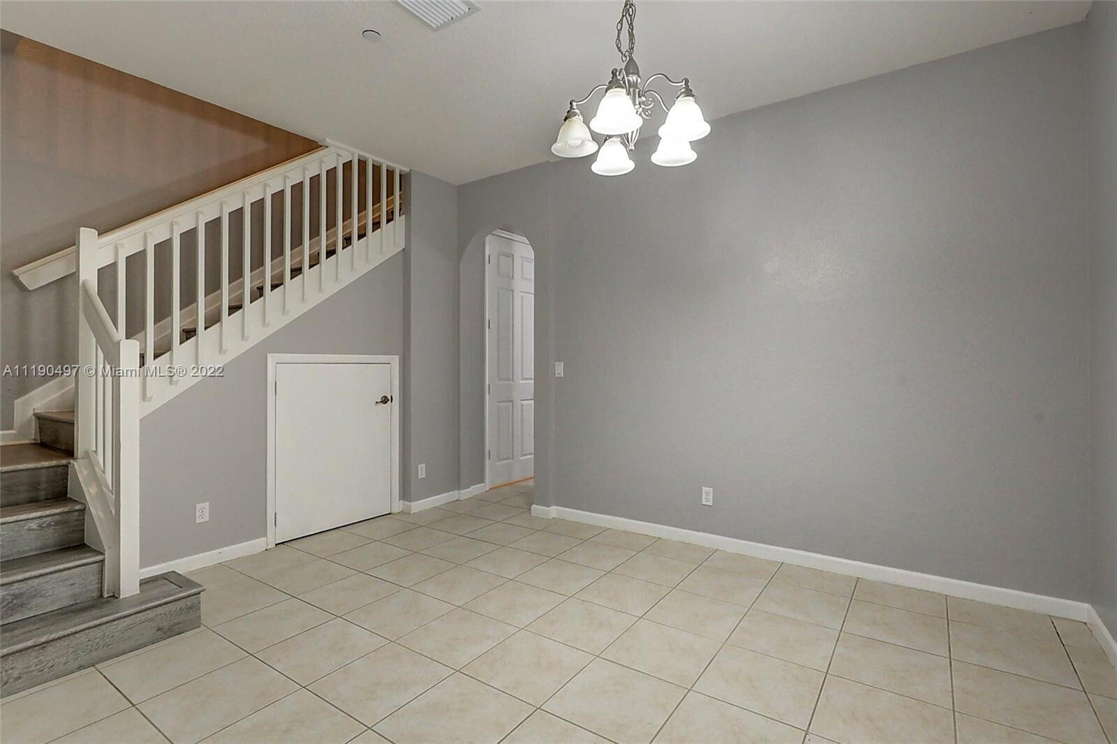 9469 Southwest Purple Martin Way Stuart, FL 34997 - Photo 18 of 21 a view of an empty room with wooden floor