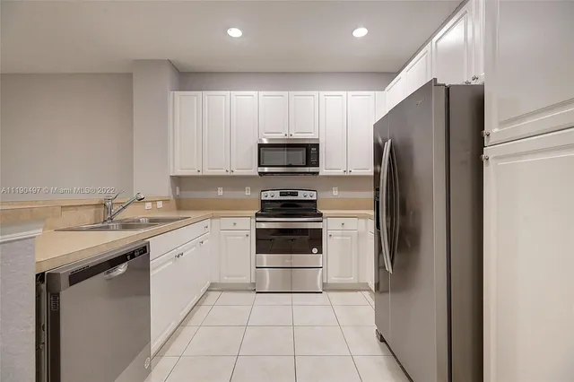 a kitchen with a sink and a refrigerator