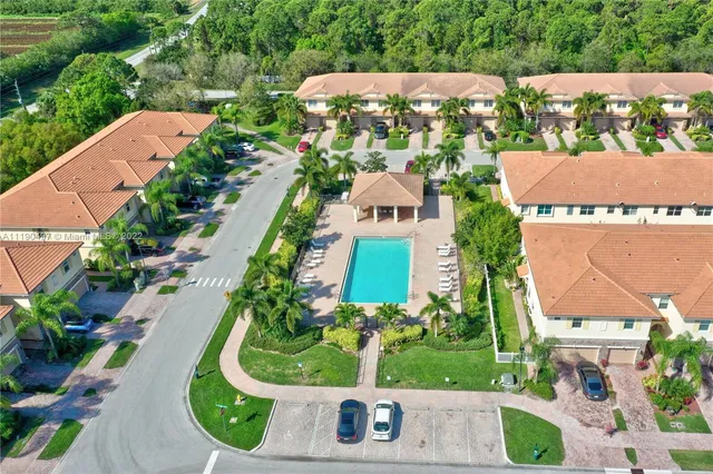 an aerial view of house with yard and swimming pool