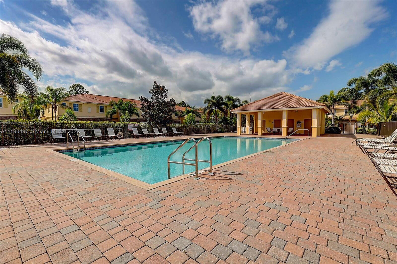 9469 Southwest Purple Martin Way Stuart, FL 34997 - Photo 4 of 21 a view of a house with a yard and potted plants