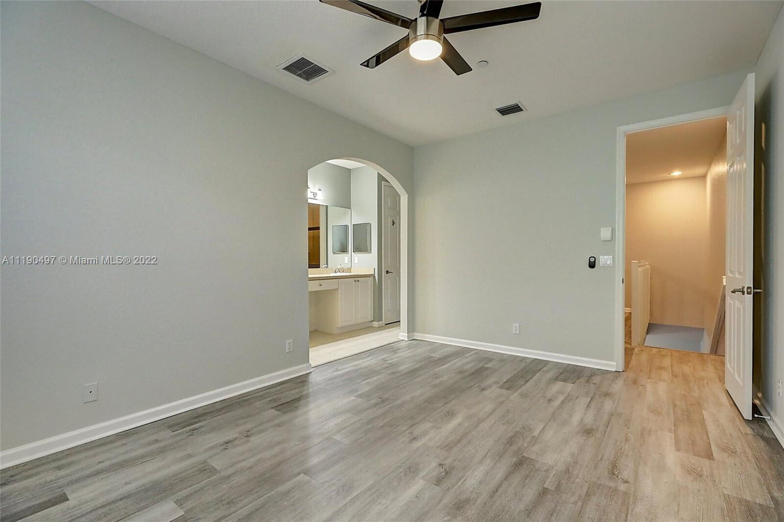9469 Southwest Purple Martin Way Stuart, FL 34997 - Photo 8 of 21 wooden floor in an empty room with a window