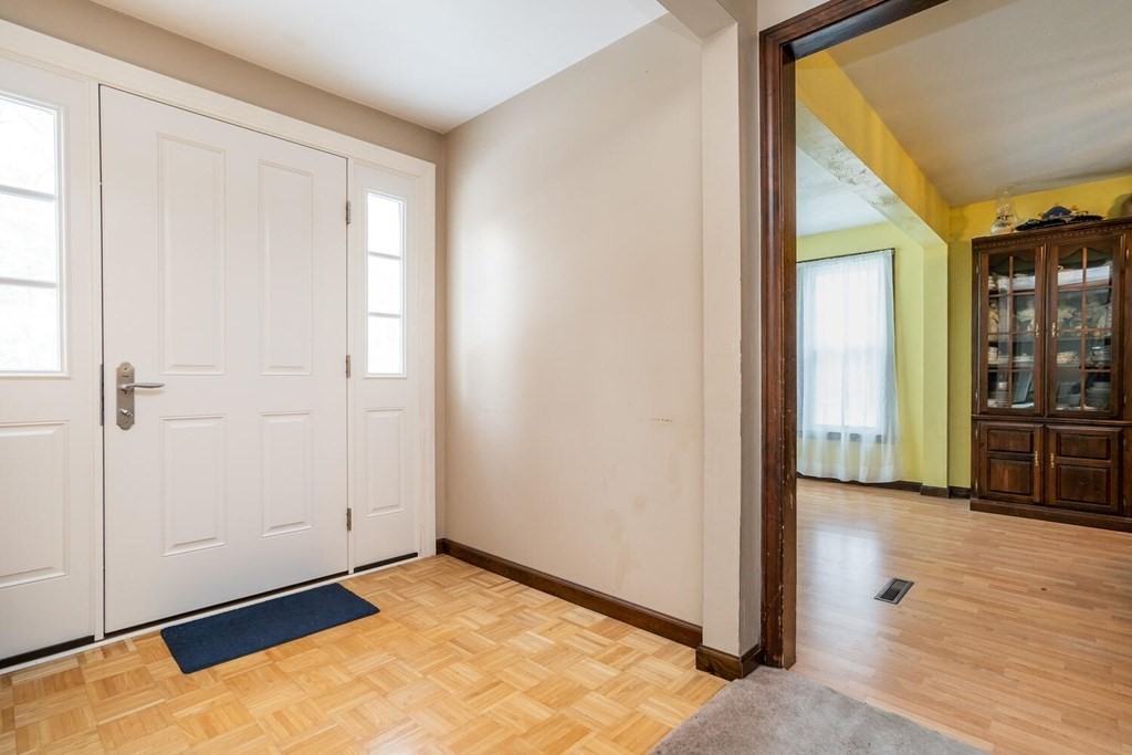 1299 Bay Road Amherst, MA 01002 - Photo 6 of 42 an empty room with wooden floor and windows