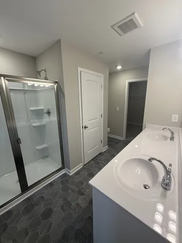 a bathroom with a sink a mirror and a shower