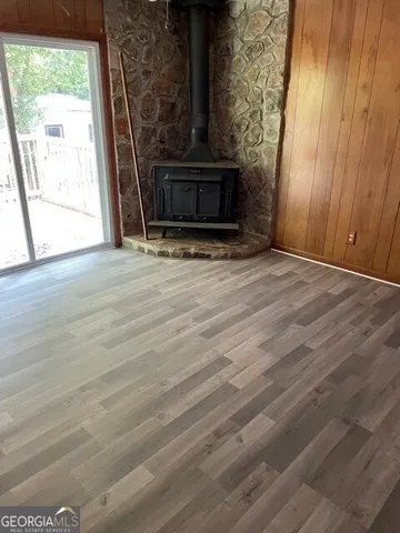 a view of a livingroom with wooden floor and a fireplace