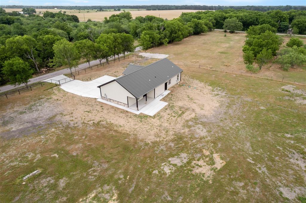 121 Brazier Road Ennis, TX 75119 - Photo 25 of 31 an aerial view of a house with a yard and lake view