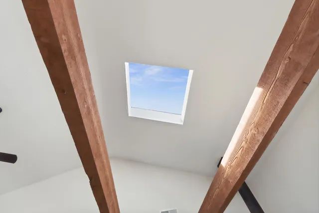 a view of a hallway to a house with stairs