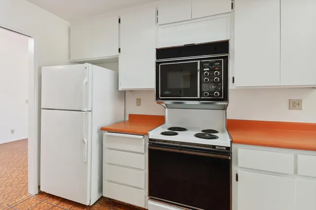 a kitchen with a stove and a microwave