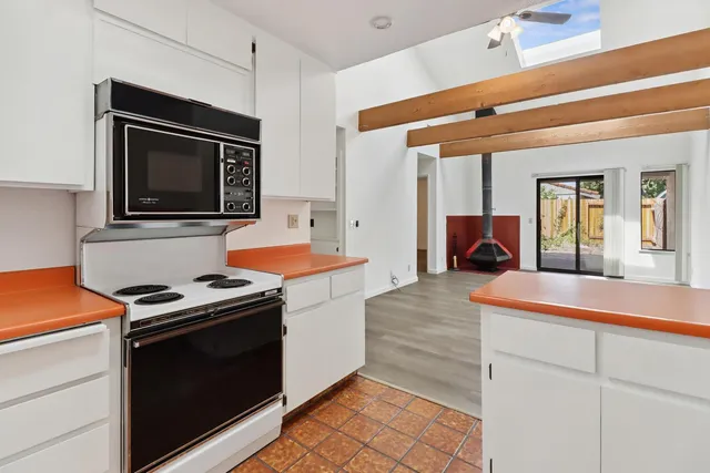 a kitchen that has a stove and a microwave